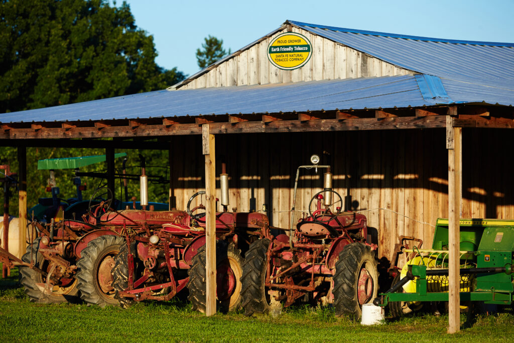A barn and tractors for the Santa Fe Natural Tobacco Company.